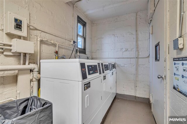 500 Linwood Dr Unit 5H, Fort Lee, NJ 07024 - shared laundry room featuring washing machine and clothes dryer, concrete block wall, and electric panel