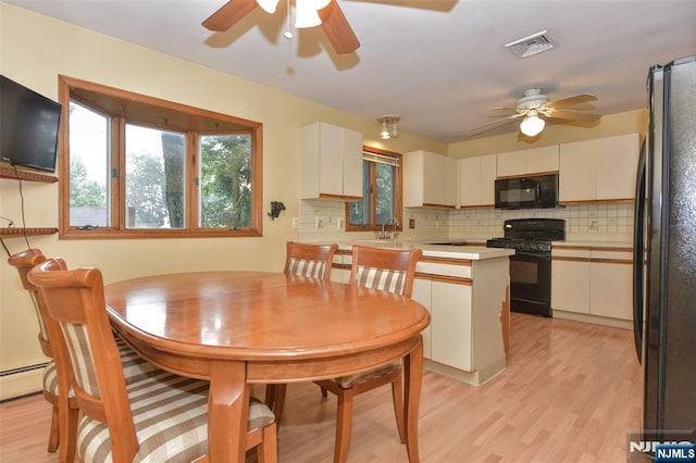 50 Grove St, Waldwick, NJ 07463 - dining area featuring ceiling fan, light wood-style flooring, and a baseboard heating unit