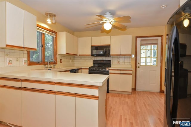 50 Grove St, Waldwick, NJ 07463 - kitchen featuring black appliances, plenty of natural light, light countertops, and a peninsula