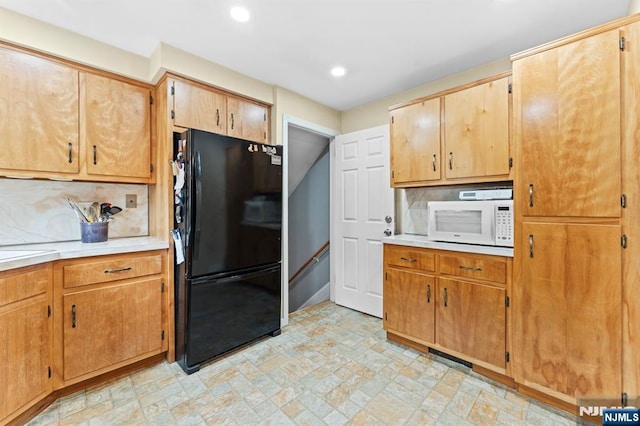 37 Furber Ave, Linden, NJ 07036 - kitchen with freestanding refrigerator, white microwave, light countertops, decorative backsplash, and recessed lighting