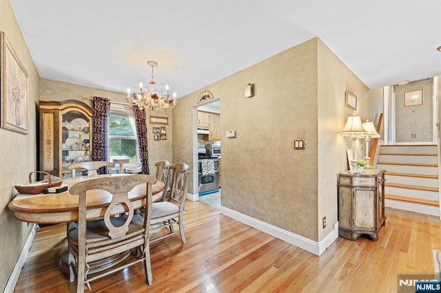37 Furber Ave, Linden, NJ 07036 - dining area with a chandelier, light wood finished floors, and stairway