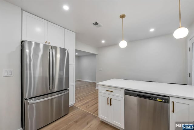97 Palisade Ave, Leonia, NJ 07605 - kitchen featuring appliances with stainless steel finishes, white cabinets, light wood finished floors, light countertops, and recessed lighting