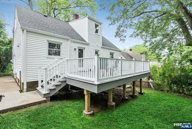 97 Palisade Ave, Leonia, NJ 07605 - rear view of house with roof with shingles, a lawn, a deck, and a chimney