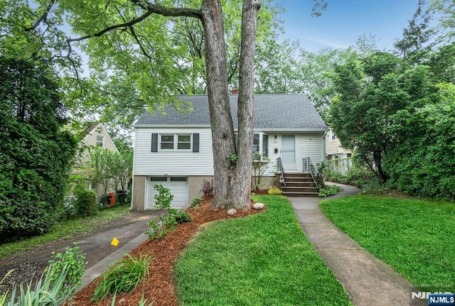 97 Palisade Ave, Leonia, NJ 07605 - view of front of house with asphalt driveway, a garage, a front yard, and roof with shingles