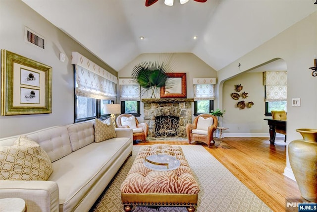 99 Chestnut Dr, Wayne, NJ 07470 - living area featuring wood finished floors, healthy amount of natural light, a fireplace, vaulted ceiling, and a ceiling fan