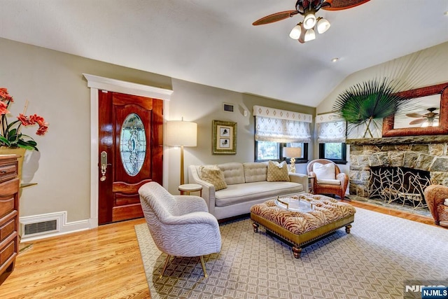99 Chestnut Dr, Wayne, NJ 07470 - living room featuring ceiling fan, light wood finished floors, a stone fireplace, and vaulted ceiling