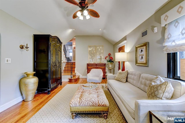 99 Chestnut Dr, Wayne, NJ 07470 - living room with wood finished floors, ceiling fan, lofted ceiling, plenty of natural light, and stairway