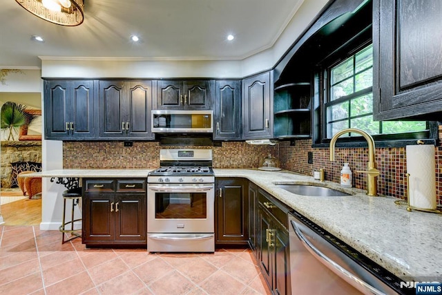 99 Chestnut Dr, Wayne, NJ 07470 - kitchen featuring appliances with stainless steel finishes, crown molding, backsplash, light tile patterned floors, and light stone counters