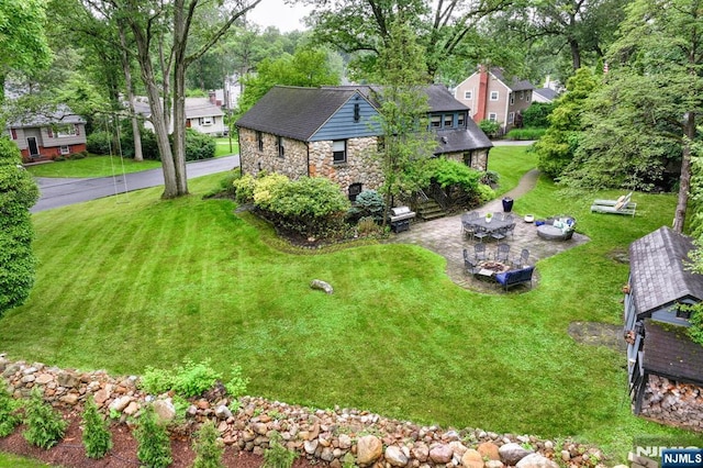 99 Chestnut Dr, Wayne, NJ 07470 - view of front of property with stone siding, a patio area, and a front lawn