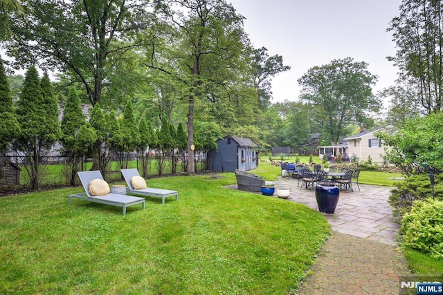 99 Chestnut Dr, Wayne, NJ 07470 - view of yard featuring a shed and a patio area