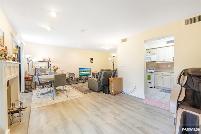 2171 Ellery Ave Unit A, Fort Lee, NJ 07024 - living area featuring light wood finished floors and a fireplace