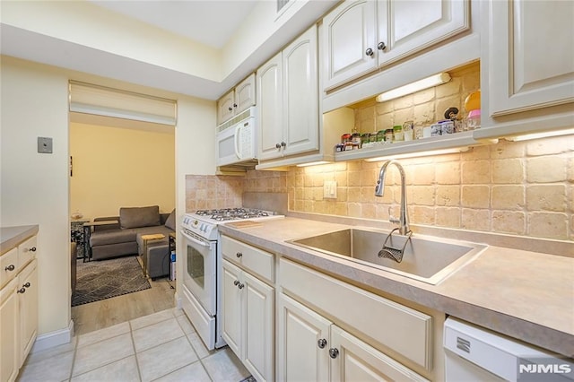 2171 Ellery Ave Unit A, Fort Lee, NJ 07024 - kitchen featuring white appliances, backsplash, light countertops, and white cabinets