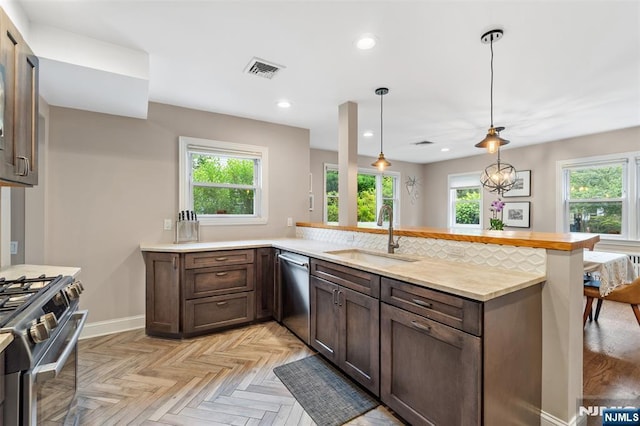37 Golf Ct, Teaneck, NJ 07666 - kitchen with appliances with stainless steel finishes, light countertops, dark brown cabinets, recessed lighting, and a peninsula