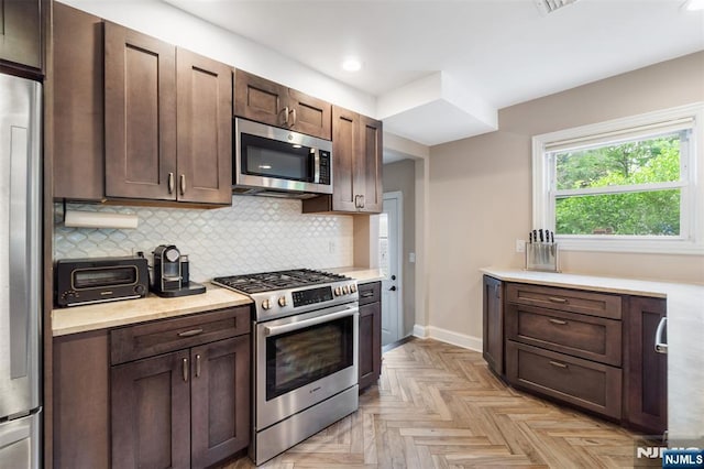 37 Golf Ct, Teaneck, NJ 07666 - kitchen with appliances with stainless steel finishes, light countertops, tasteful backsplash, dark brown cabinetry, and recessed lighting