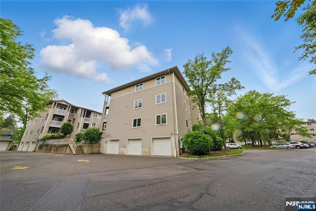223 Orchard Park, Allendale, NJ 07401 - view of property featuring an attached garage and driveway