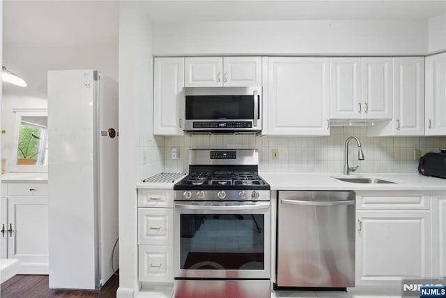 223 Orchard Park, Allendale, NJ 07401 - kitchen featuring stainless steel appliances, light countertops, white cabinets, and tasteful backsplash