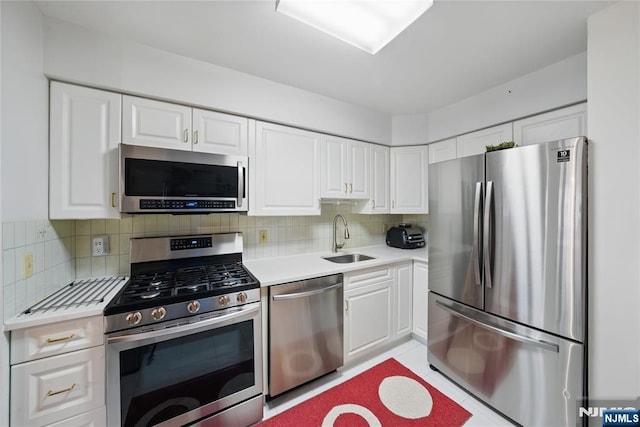223 Orchard Park, Allendale, NJ 07401 - kitchen with stainless steel appliances, light countertops, white cabinetry, backsplash, and light tile patterned floors