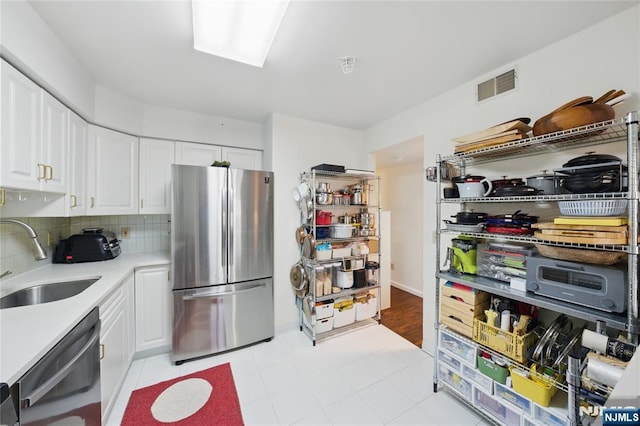 223 Orchard Park, Allendale, NJ 07401 - kitchen with appliances with stainless steel finishes, light countertops, white cabinets, and tasteful backsplash