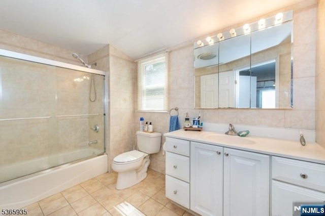 362 Valley Rd, Wayne, NJ 07470 - full bathroom with tile walls, vanity, tile patterned flooring, and shower / bath combination with glass door