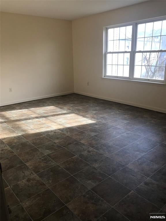 202 Harrison St, Paterson, NJ 07501 - spare room featuring baseboards