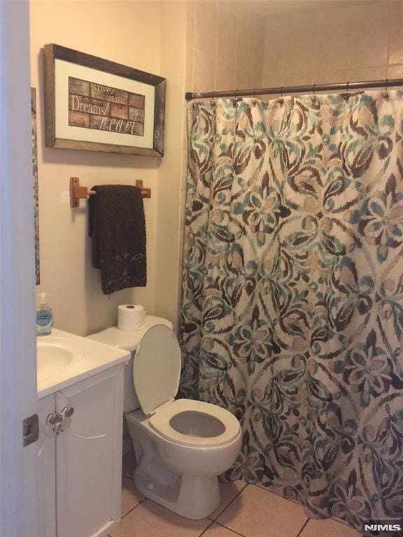 202 Harrison St, Paterson, NJ 07501 - bathroom featuring tile patterned flooring, vanity, and curtained shower