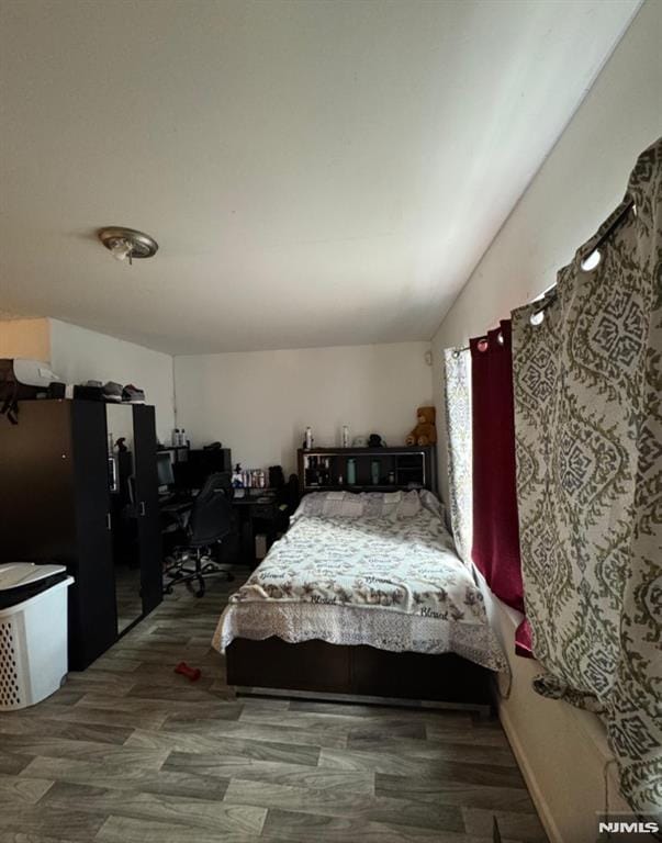202 Harrison St, Paterson, NJ 07501 - bedroom featuring a desk, lofted ceiling, and wood finished floors