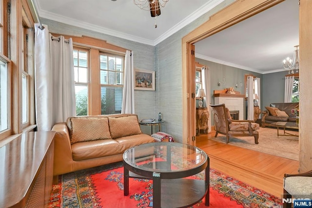 116 Sherman Ave, Teaneck, NJ 07666 - living area with wood finished floors, a chandelier, plenty of natural light, ornamental molding, and wallpapered walls