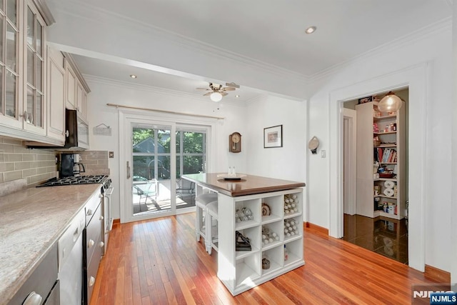 116 Sherman Ave, Teaneck, NJ 07666 - kitchen featuring open shelves, light wood-style flooring, tasteful backsplash, glass insert cabinets, and crown molding