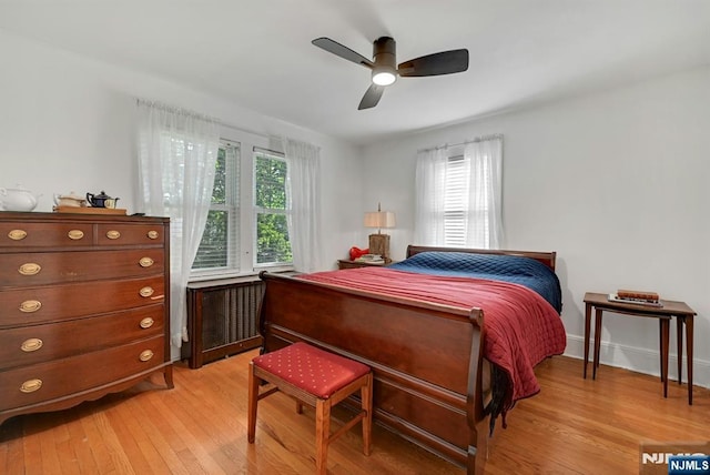 116 Sherman Ave, Teaneck, NJ 07666 - bedroom with radiator heating unit, multiple windows, light wood finished floors, and ceiling fan