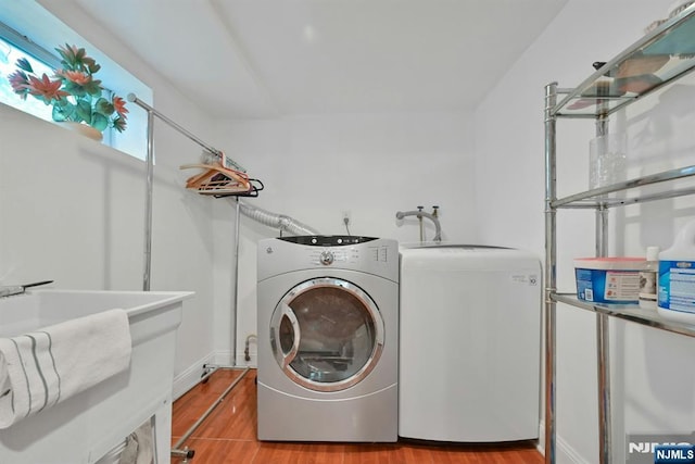 116 Sherman Ave, Teaneck, NJ 07666 - laundry room with separate washer and dryer and light wood-style floors