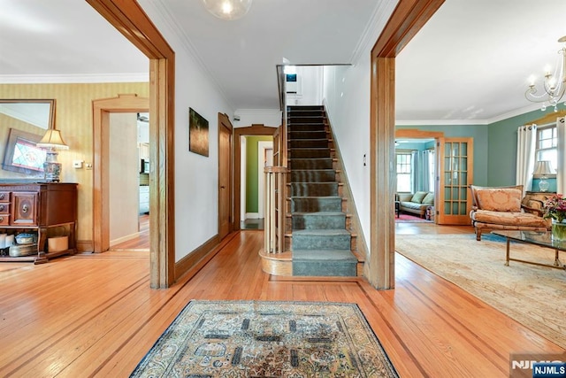 116 Sherman Ave, Teaneck, NJ 07666 - stairway with hardwood / wood-style floors, crown molding, and a chandelier