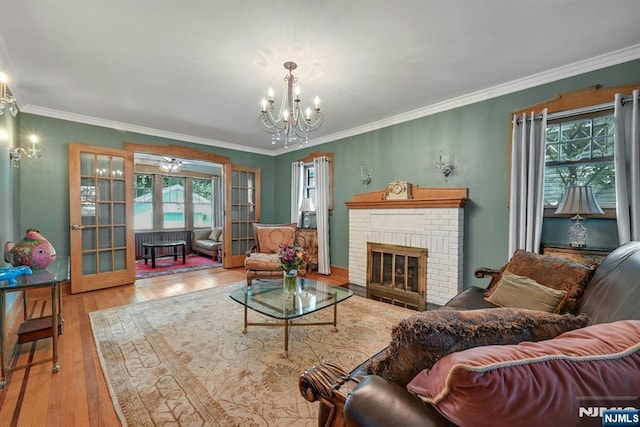 116 Sherman Ave, Teaneck, NJ 07666 - living area featuring plenty of natural light, french doors, a chandelier, wood finished floors, and crown molding