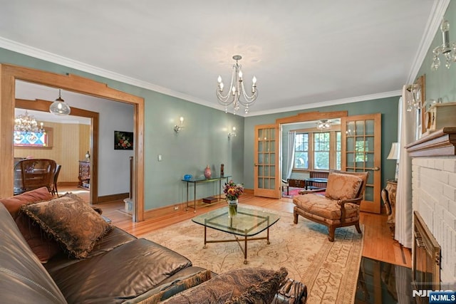 116 Sherman Ave, Teaneck, NJ 07666 - living room with a chandelier, a brick fireplace, wood finished floors, and ornamental molding