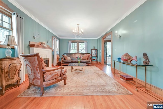 116 Sherman Ave, Teaneck, NJ 07666 - living area with hardwood / wood-style floors, a chandelier, ornamental molding, and a brick fireplace