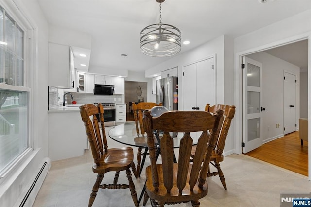 890 Ridgewood Ave, Oradell, NJ 07649 - dining room with a baseboard radiator, light tile patterned floors, a chandelier, and recessed lighting