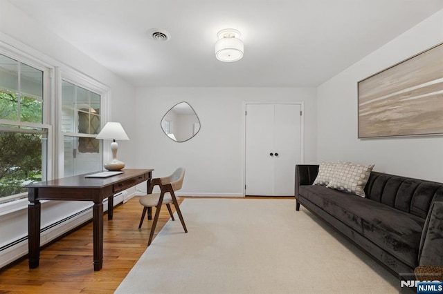 890 Ridgewood Ave, Oradell, NJ 07649 - office area with light wood-type flooring and a baseboard heating unit