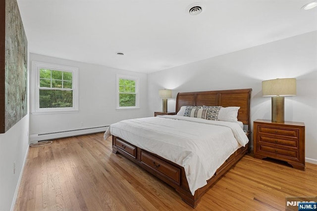 890 Ridgewood Ave, Oradell, NJ 07649 - bedroom featuring a baseboard radiator and light wood-style flooring