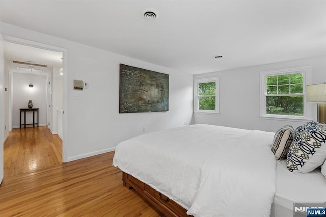890 Ridgewood Ave, Oradell, NJ 07649 - bedroom featuring light wood-type flooring and attic access
