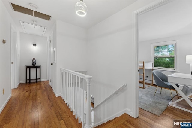 890 Ridgewood Ave, Oradell, NJ 07649 - hall with attic access, an upstairs landing, wood finished floors, an office area, and a baseboard heating unit