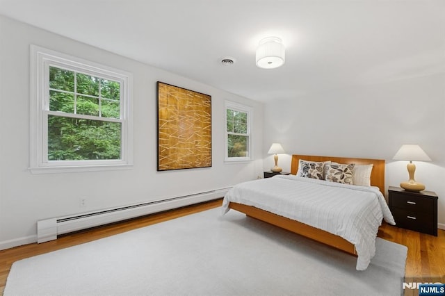 890 Ridgewood Ave, Oradell, NJ 07649 - bedroom featuring baseboard heating and wood finished floors