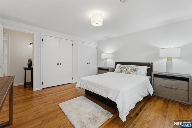 890 Ridgewood Ave, Oradell, NJ 07649 - bedroom featuring light wood-style floors and multiple closets