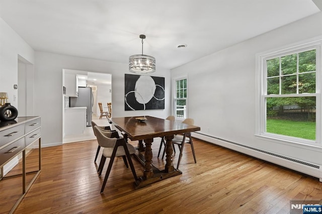 890 Ridgewood Ave, Oradell, NJ 07649 - dining area featuring a baseboard radiator, plenty of natural light, light wood-style flooring, and a chandelier
