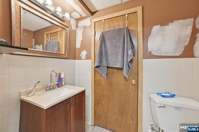 155 8th, Hawthorne, NJ 07506 - bathroom featuring tile walls, vanity, and wainscoting