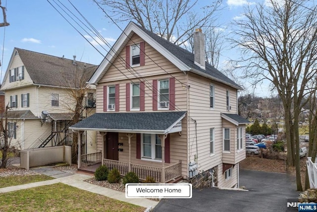 87 James St, Englewood, NJ 07631 - view of front of home featuring covered porch, a chimney, roof with shingles, and asphalt driveway