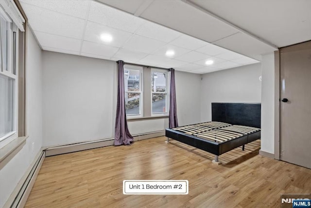87 James St, Englewood, NJ 07631 - bedroom featuring a baseboard heating unit, wood finished floors, and recessed lighting
