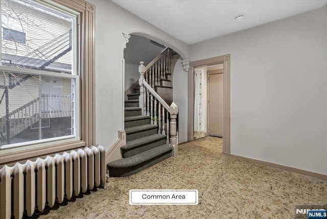 87 James St, Englewood, NJ 07631 - stairs with radiator heating unit and arched walkways