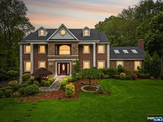 8 Oratam Rd, Upper Saddle River, NJ 07458 - colonial home with a front yard, stone siding, and brick siding