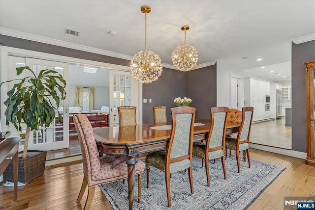 8 Oratam Rd, Upper Saddle River, NJ 07458 - dining area featuring a chandelier, light wood-style floors, and ornamental molding