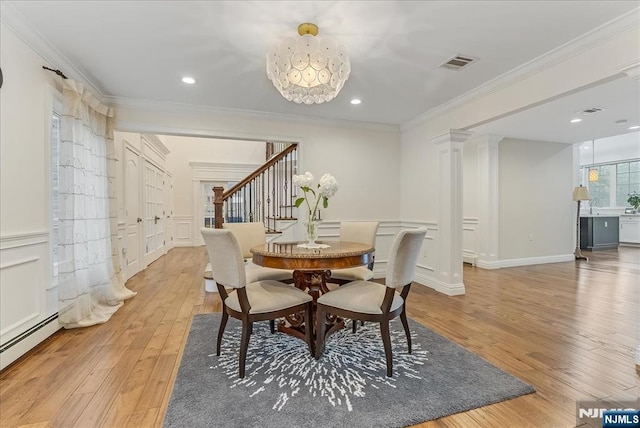 8 Oratam Rd, Upper Saddle River, NJ 07458 - dining area with light wood-style floors, ornate columns, ornamental molding, stairway, and a decorative wall