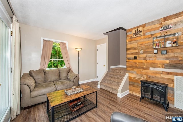 15 Mason St, Jefferson Township, NJ 07849 - living room with wood finished floors, a wood stove, and wood walls